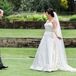 Mary Kait chose this stunning A-line dress for her natural wedding. She loved that it correlated with how she dresses day-to-day: basic with accessories. She added on the pearl belt, lace veil and pale blue shoes.