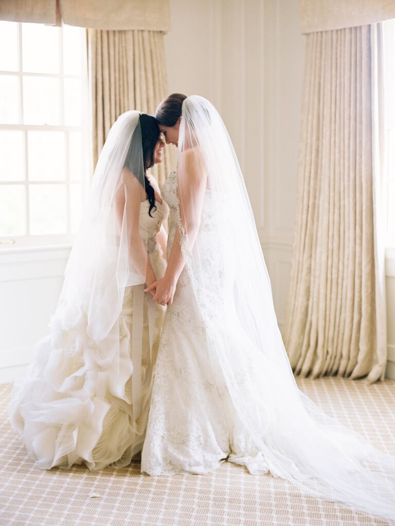 Brides holding hands and smiling