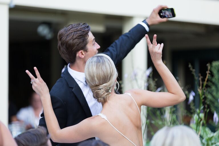 Couple posing in front of an iPhone