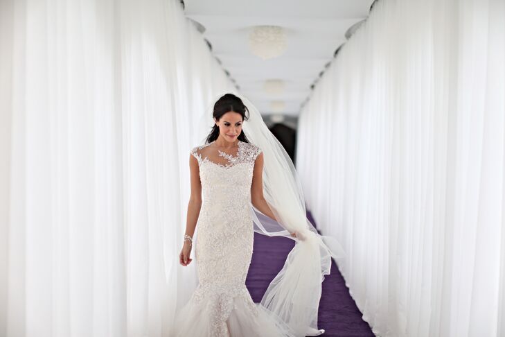Colleen wore an ivory Reem Acra wedding dress in a mermaid style, which had a beautiful lace pattern on the sleeves that trickled all the was down to where the tulle skirt flared out. She also wore a long ivory tulle veil to complement the look.