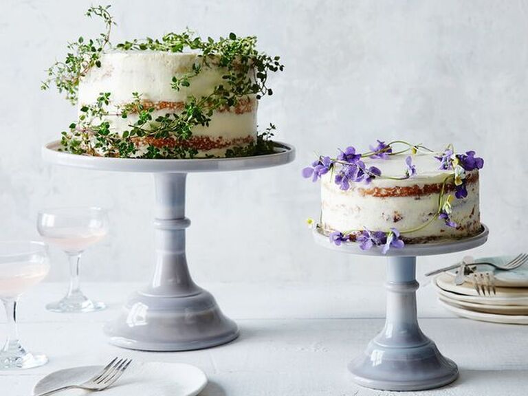 Pale pastel tall wedding cake stand in smaller and larger size with pretty floral decorated cakes