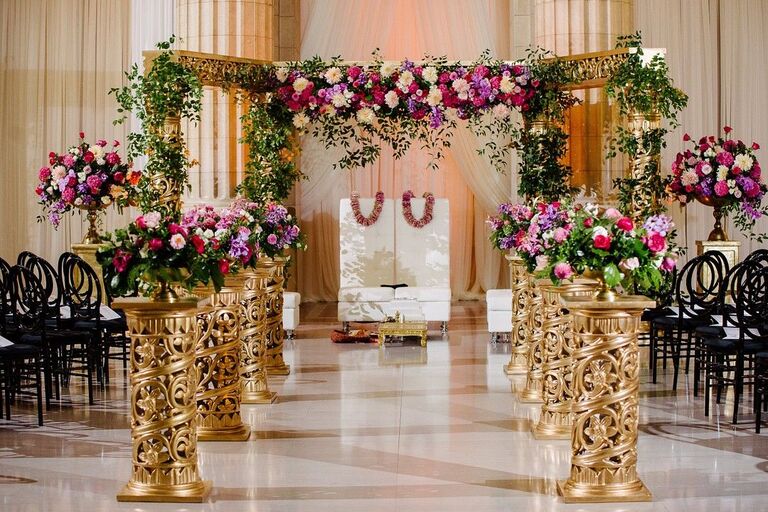 Gold-and-purple mandap in ballroom