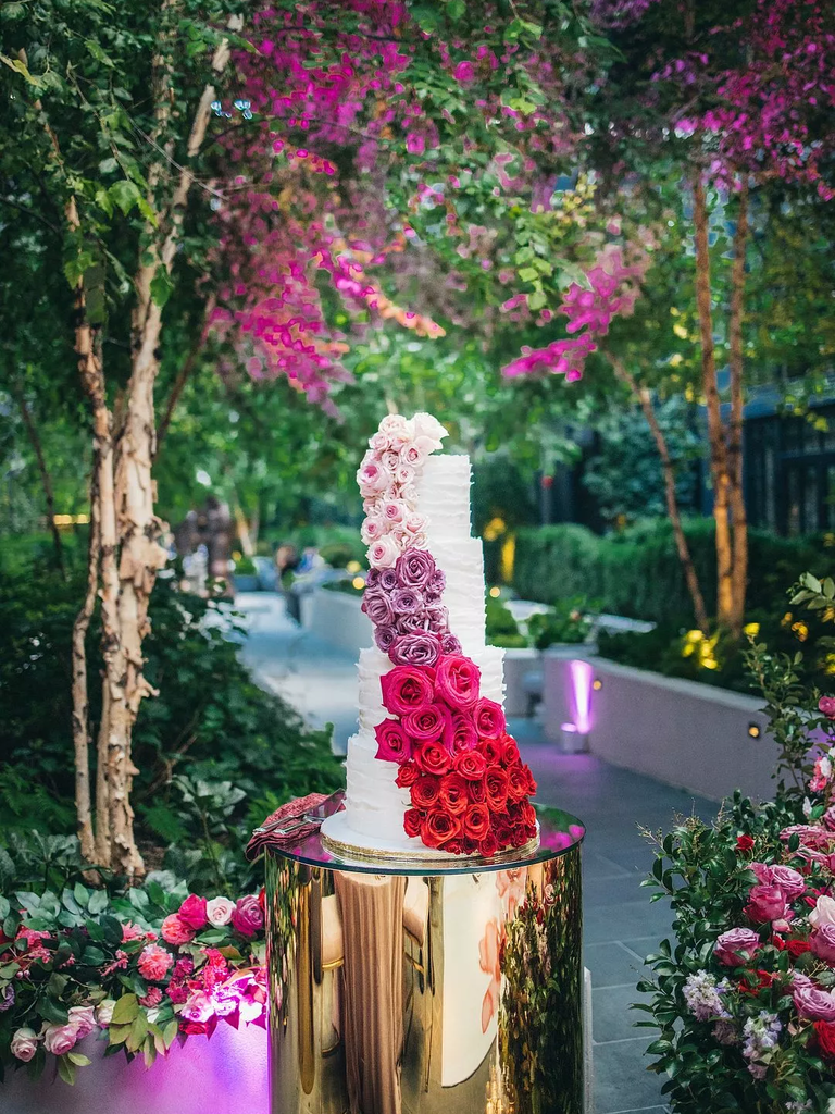 Four-tier Wedding Cake With Ombré Roses in pink, blush, and red