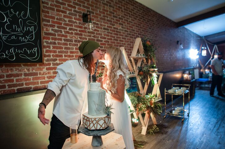 "Our cake was so cool," Christa says. "It was three tiers with marble and gold accents, all vanilla filled under the most gorgeous fondant. We did not have a topper, but we did have the most amazing air plant on the side of the cake to add a spark of green."