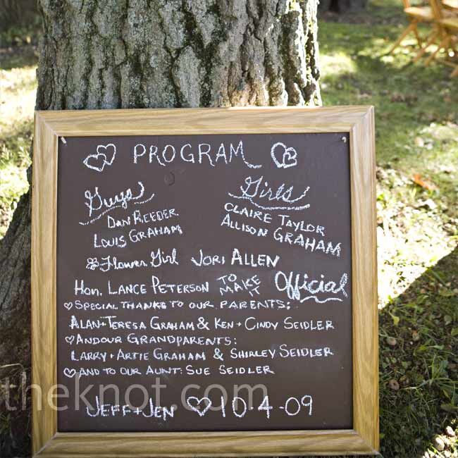 Rather than traditional paper programs, Jen and Jeff wrote out the names of their wedding party and parents on a chalk board and propped it against a tree.