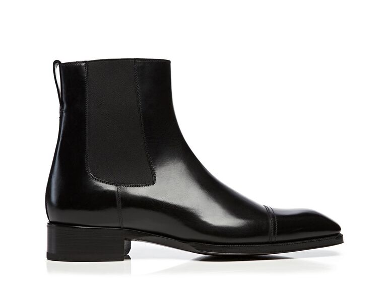 Shiny black leather boots with a chunky heel. 