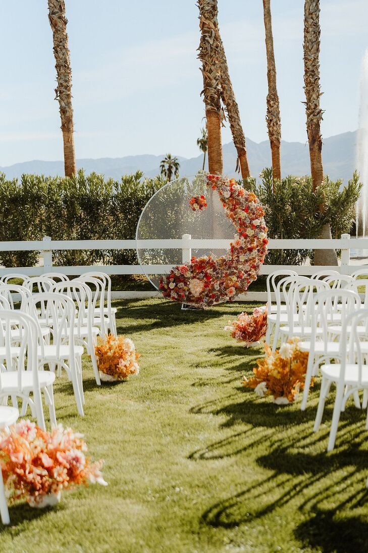 Circular Floral Structure at Ceremony Altar With Bright Flowers at Desert Wedding