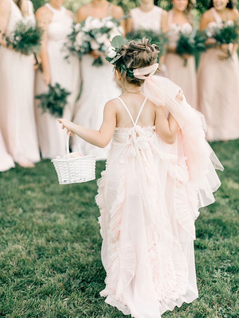 Flower girl in bohemian pink dress with bridesmaids