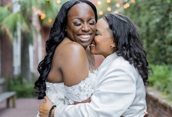 two brides snuggling and laughing
