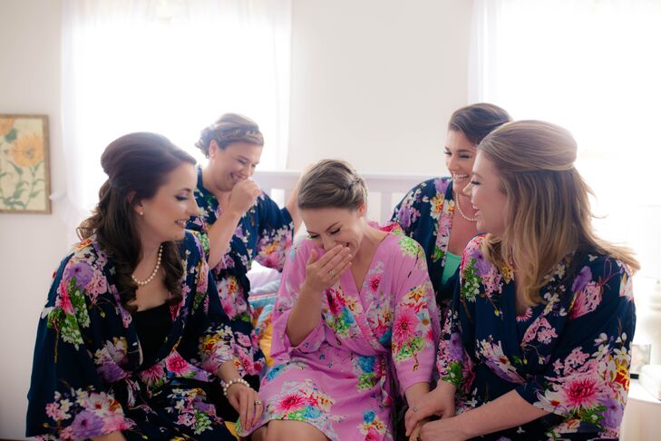 From the beginning of the day, Emily and her bridesmaids made sure they had fun. Decked out in matching navy and fuchsia floral robes from Etsy, they sipped mimosas and snagged a few group photos with Allie Skylar Photography. After they got ready with chic down and updo hairstyles from Elite Hair Color and Designs, Mariah Rodriguez, from Makeup By Roxy, finished their classic beauty looks.