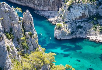 best honeymoon destinations a beautiful photo of gordes south of france with massive rocks and teal blue water plus kayaks