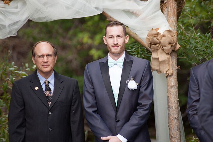 While Melissa got busy handcrafting everything from the flowers to the signs, Dustin took on a few DIY projects of his own. With the help of Melissa’s father, Dustin made the wedding arch for the ceremony from locally sourced tree branches and decorated with tulle panels and burlap bows. The arch meshed perfectly with the couple’s rustic, vintage theme, while complementing the ceremony’s natural setting.