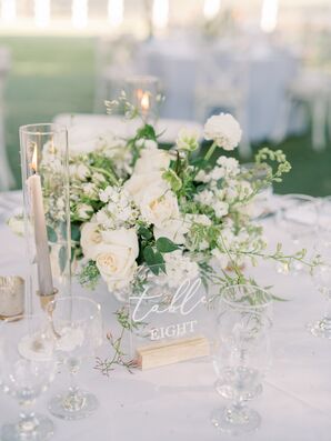White Flower Centerpiece Beside Acrylic Table Number