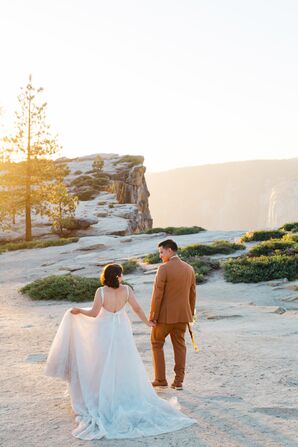 Bride in A-Line Gown, Groom in Burnt Orange Suit Walking on Mountain in Yosemite