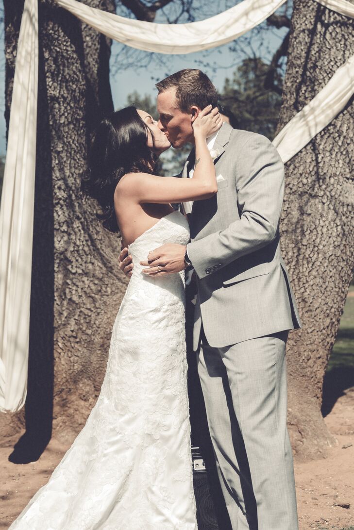 Sarah and Kolton shared their first kiss next to trees wrapped in white linens.