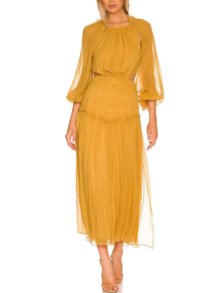 Model wearing a long sleeve dress in marigold