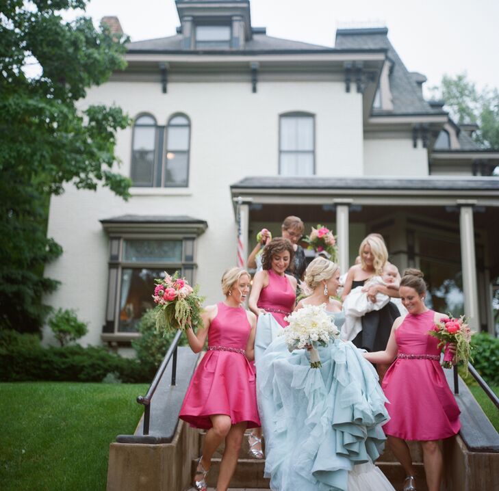 The bridesmaids donned knee-length fuchsia Monique Lhuillier gowns for the pink and gold wedding. They completed their look with crystal sashes and strappy silver heels. Their cascading pink and green bouquets brought the Shakespearian theme into the overall look.