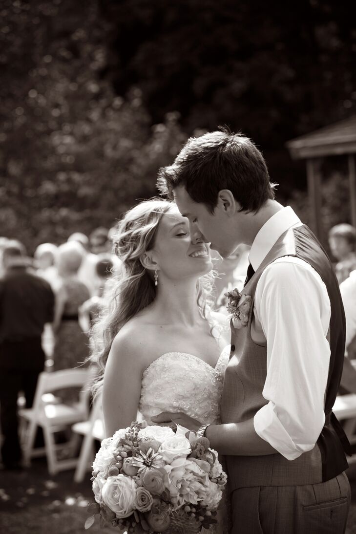 The couple said "I do" in an outdoor ceremony at the end of the beach under a wooden archway covered in flowers.