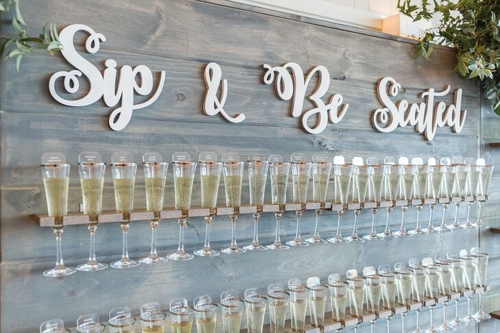 Champagne Wall Escort Cards with Whimsical Signage
