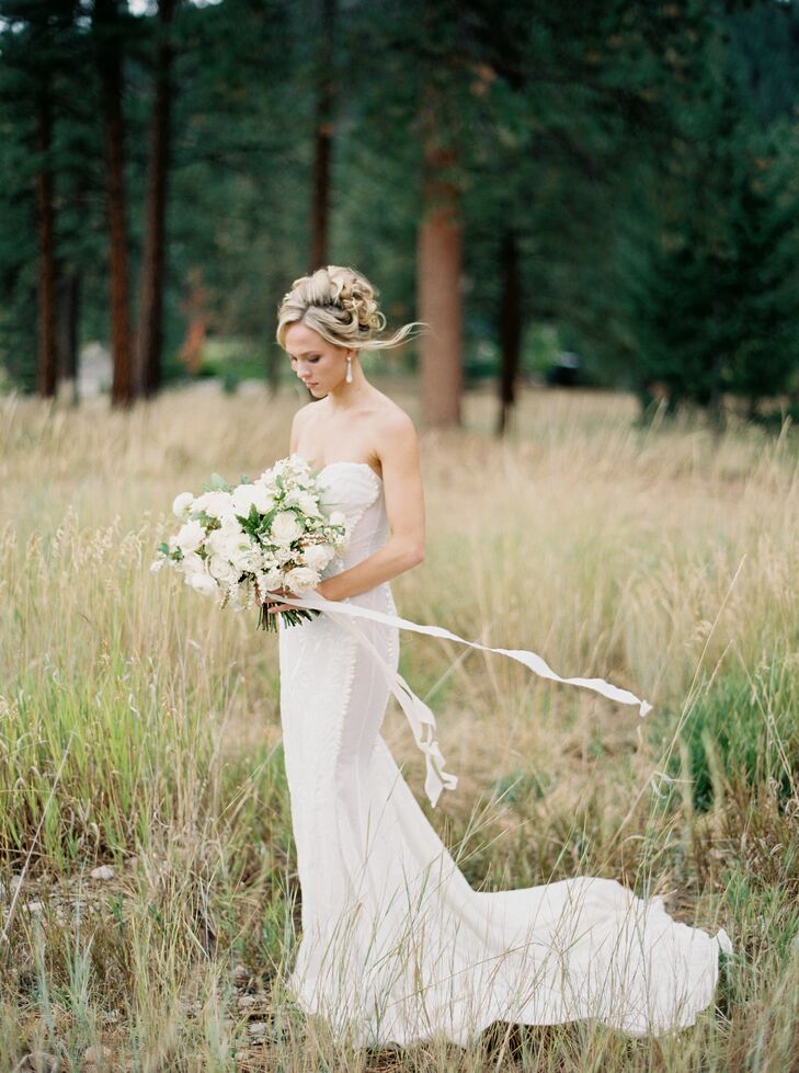 The minute Morgan tried on her sheath-cut Galia Lahav gown, she was in love. With a strapless sweetheart neckline, geometric embroidery, form-fitting mermaid-style silhouette and sheer paneling through the sides, it was “a little edgy,” she says. “So I wore a very traditional cathedral-length veil to help balance it out for the ceremony.”