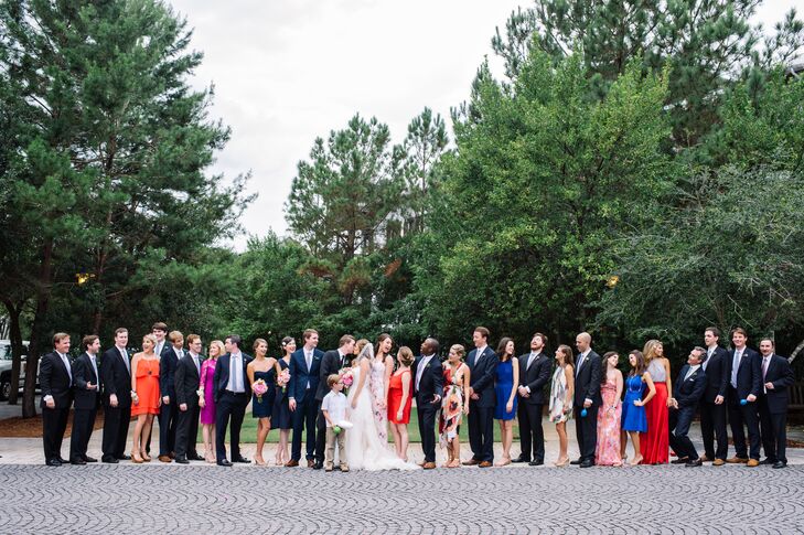 Caroline and Christopher's wedding party included almost every color. All the groomsmen, including his best man, wore navy suits with white shirts and gingham ties, creating a uniform look. Their bridesmaids, however, donned dresses in all their favorite colors, prints and styles. Caroline’s two sisters stood out from the pack with navy blue dresses and pink bouquets. The rest of the women wore flowers in their hair.