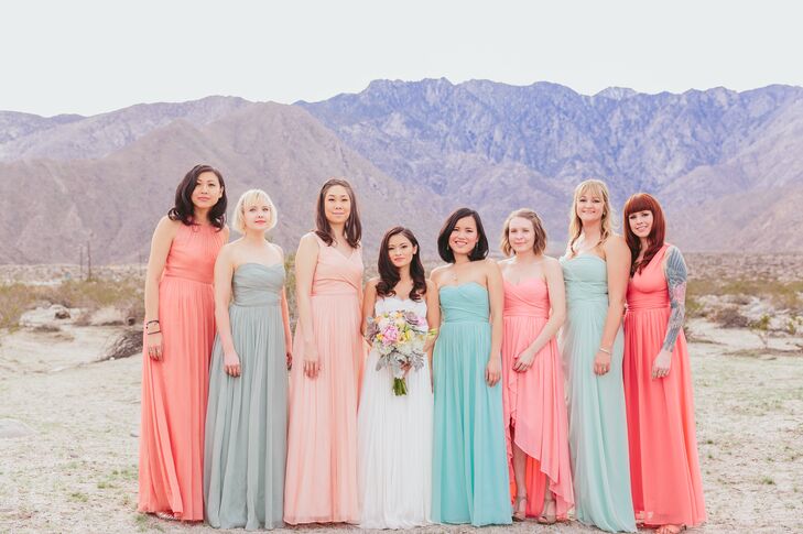 The bridesmaids wore floor-length dresses in a variety of styles and soft colors. Liz loved the idea of the elegant, pink and pastel dresses against the desert backdrop.