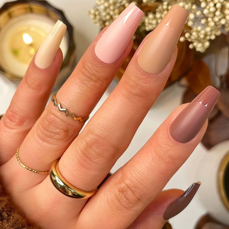 Colorful coffin-shaped press on nails in warm alternating neutral shades. 