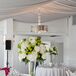 The Sunset Restaurant is where the wedding reception was held, which was decorated in white linens and accented with white rose and hydrangea centerpieces.