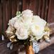 Christine carried white roses, hydrangeas, garden roses and dusty miller accents with spray painted gold leaves to match the ivory, blush and gold color palette.