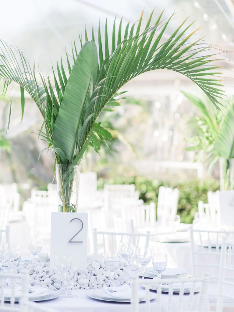 tall modern greenery wedding centerpiece with palm fronds