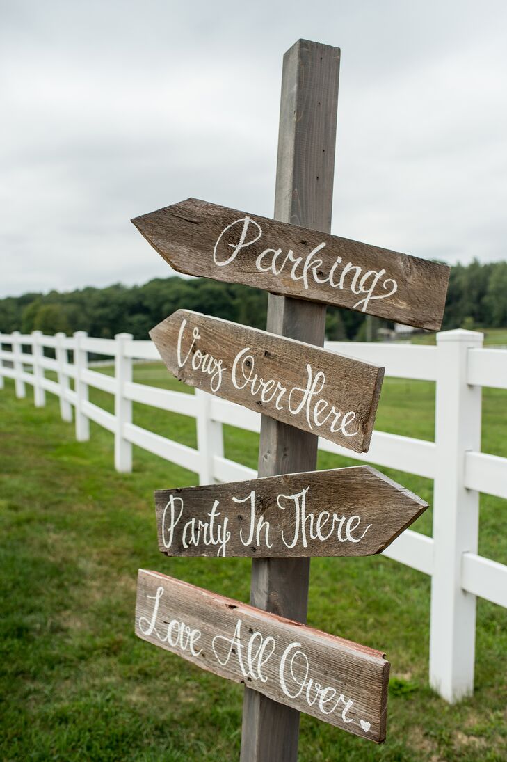 Guests were directed to the ceremony and the reception with this handmade wooden sign post at T.C. and Gabrielle's wedding on Friedman Farms.