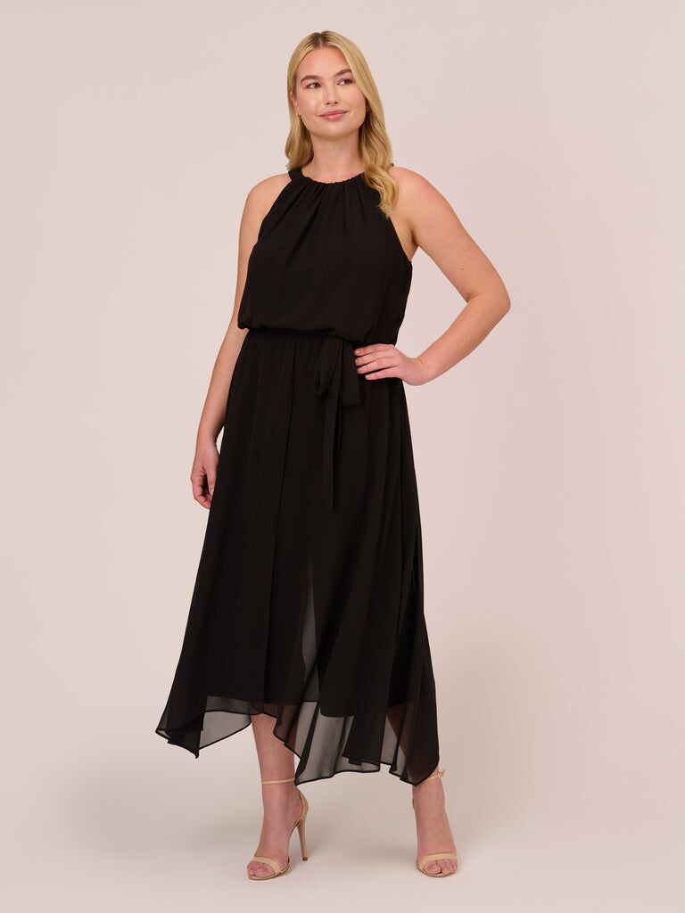 Model wearing a black halter-neck jumpsuit with chiffon skirt