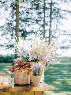 Baskets With Multicolored Wildflowers on Wood Bar at Summer Reception