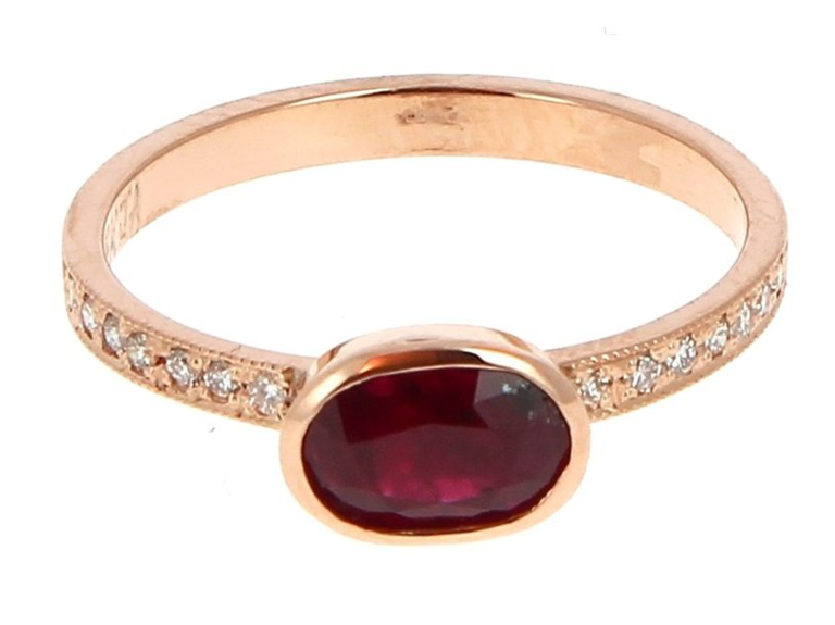 Oval ruby center stone on rose gold pave diamond band