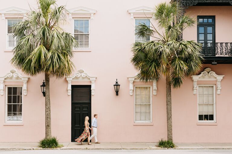 Couple walking in downtown Charleston during summer engagement session