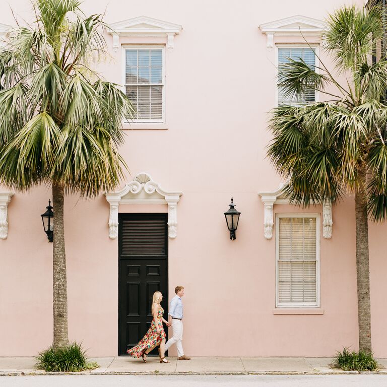 Couple walking in downtown Charleston during summer engagement session