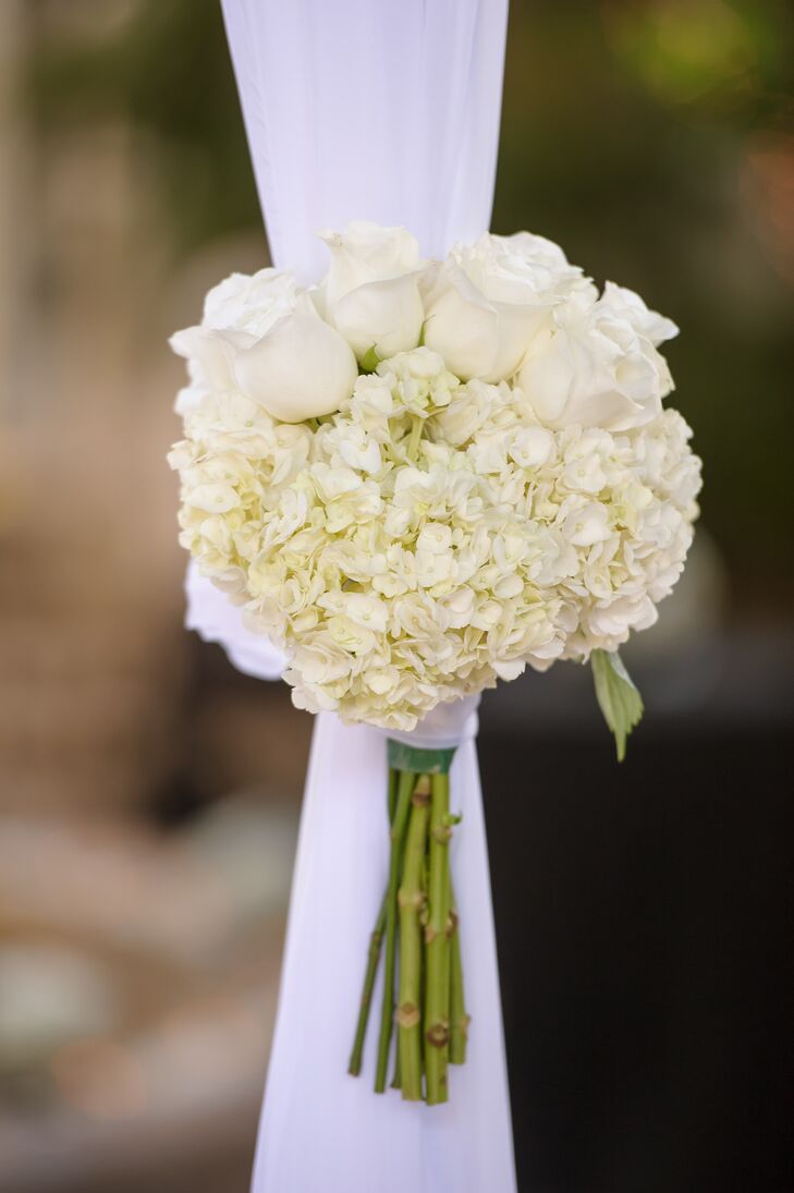 Melissa and Derek decorated their wedding with only a few simple accents. The couple's white fabric-draped chuppah was met with two bouquets of white roses and white hydrangeas designed by their florist, Dalsimer Atlas. Their team also made an all-white bouquet for Melissa.