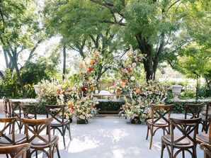 Outdoor Ceremony With Lush, Vibrant Altar With Greenery, Bright Flowers