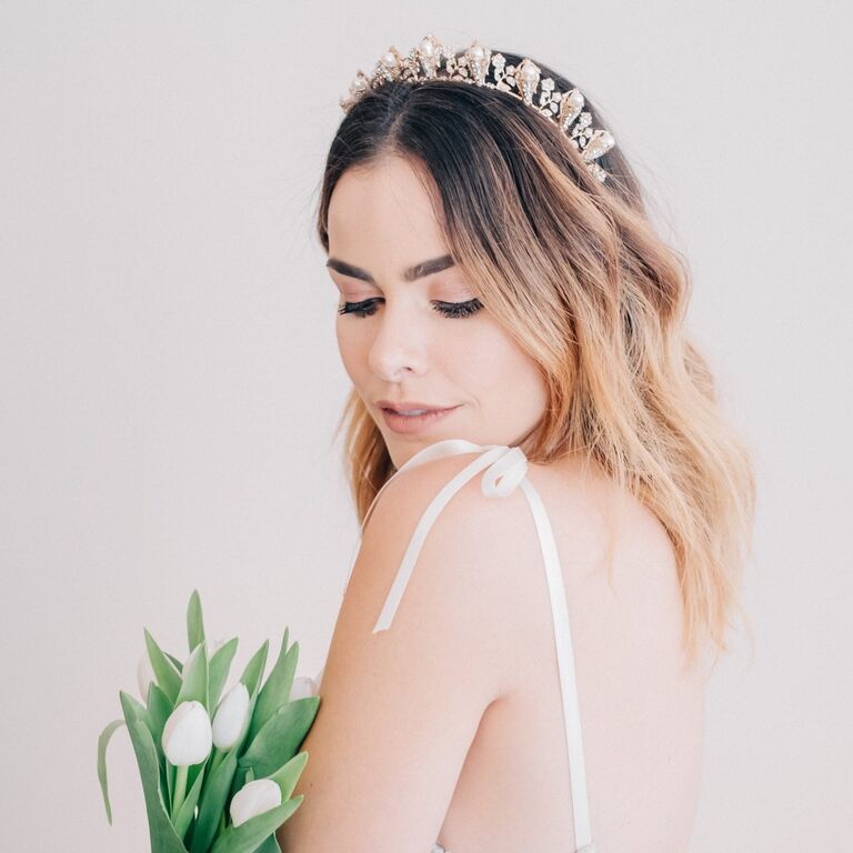 Model wears a beautiful headband with pearl accents. 
