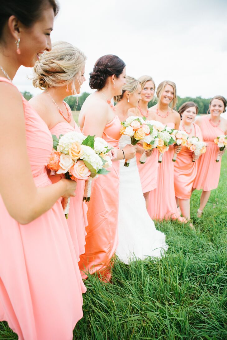 The bridesmaids hand-selected their own coral-colored dresses in mismatched satin and chiffon fabrics and either long or short styles. They paired these with custom-made jewelry by Alex's mother, and they carried matching white and coral bouquets with hydrangeas and large garden roses.
