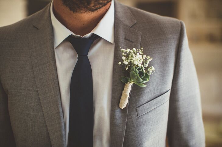 Colin had a succulent and baby's breath wrapped boutonniere pinned to his light gray jacket.