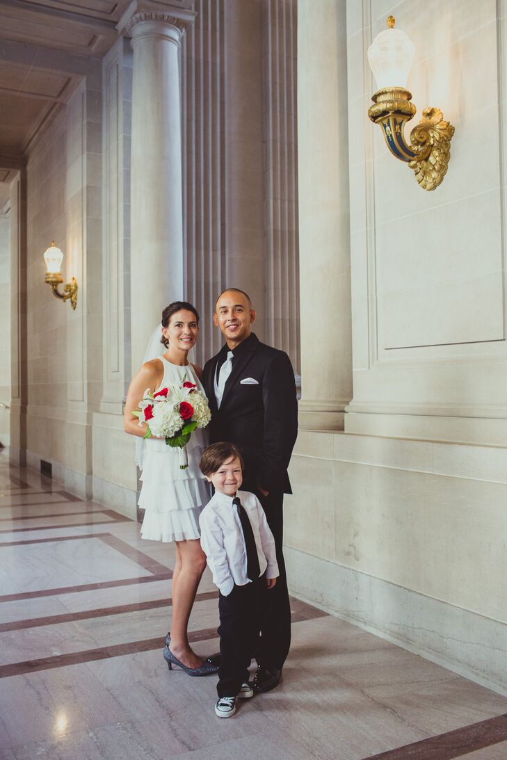 The bride and groom posed with a young family member at the San Francisco City Hall.