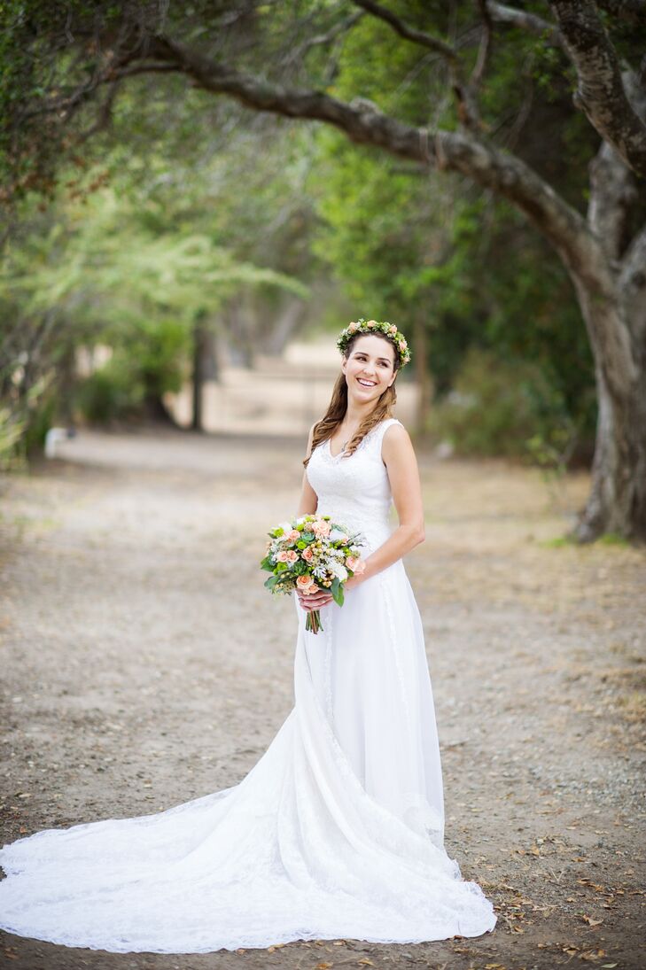 Danielle wore a refurbished version of her mother's wedding gown. "We completely transformed her old dress, thanks to our seamstress, Lori Le at Elegant Design Boutique," Danielle says. "We removed the lace sleeves, cut the turtle neck off and added new bustles for the beautiful train. The lace overlay was vintage and very much fit in with our theme."