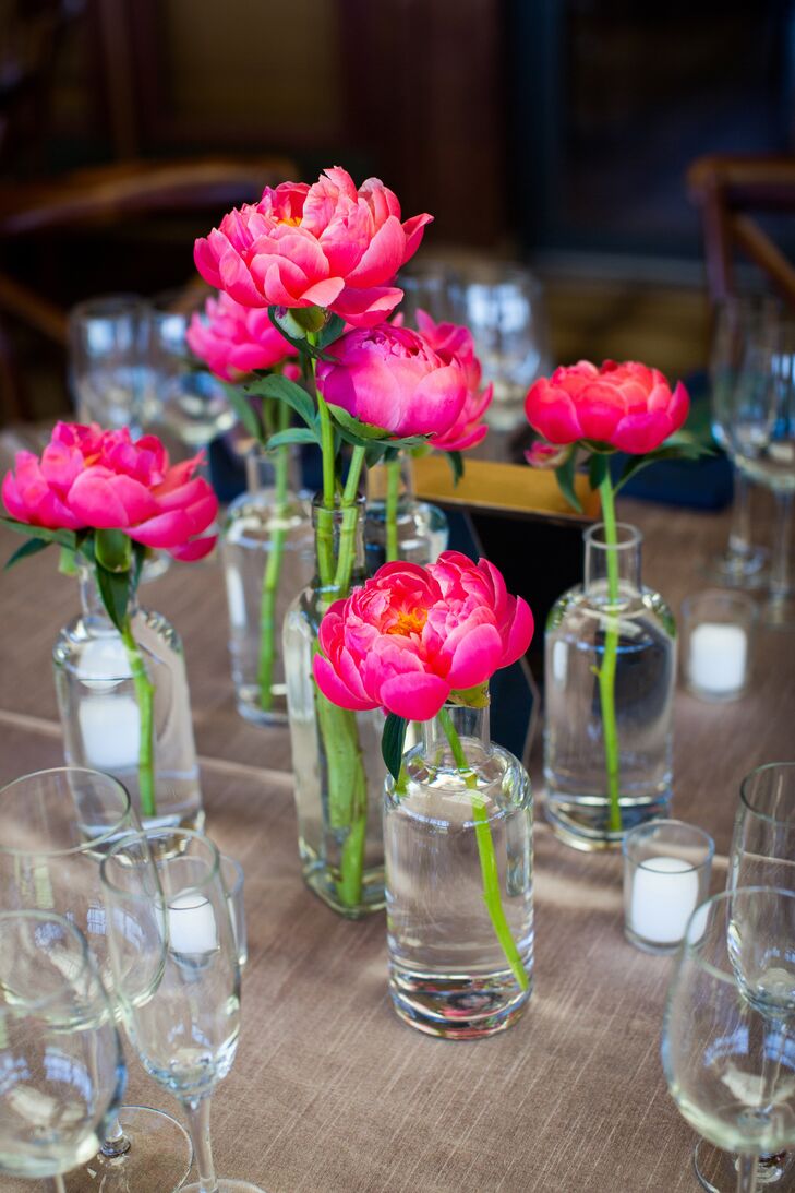The centerpieces were small glass bottles filled with individual peony stems. My main request to the florist was to incorporate peonies, if possible, into my bouquet, Jennifer says. She warned that it might be too early in the season for peonies, so I was thrilled that she was able to get them after all!