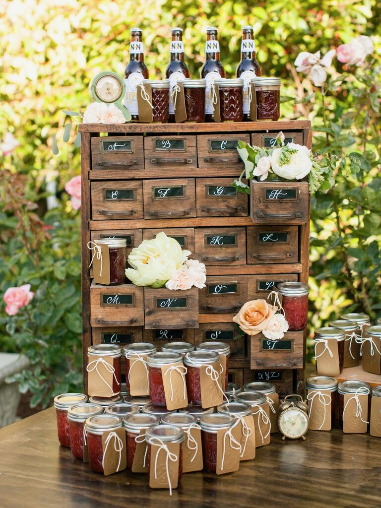 wedding favor display with vintage wooden file card cabinet and jars of homemade fruit jam