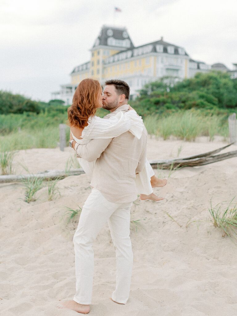 Couple shares a sweet kiss on a beautiful beach. 