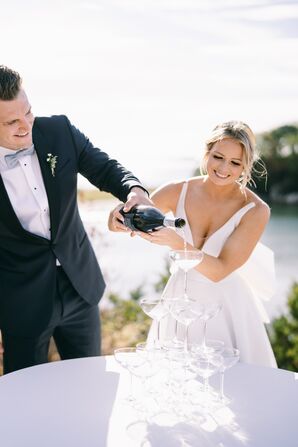 Couple Pouring Champagne for Champagne Tower at Nautical Wedding