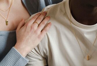 Couple wearing matching necklaces