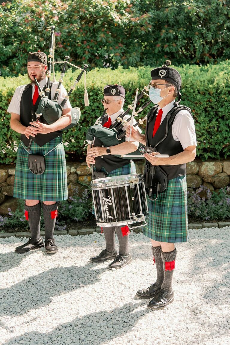 Three bagpipers performing at wedding