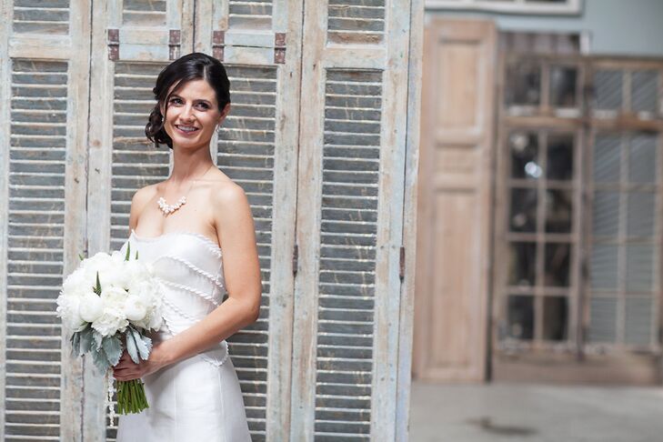 Danielle’s wedding dress was the perfect complement to the wedding’s modern-meets-rustic-chic aesthetic. The gown featured a classic A-line silhouette, a strapless sweetheart neckline and decorative scalloped seams along the bodice that added depth and dimension to the design. “I fell in love with the lines and the structure of the dress,” says Danielle. “I bought it as a sample, so I did some major tailoring and editing to make it fit my body just perfectly.”